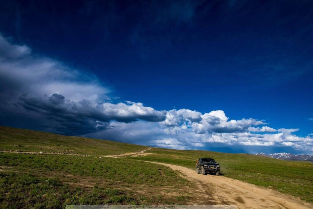 4x4 jeep on a mountain track with the Haldi Cones granite peaks in the background, Ghanche District