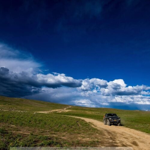 4x4 jeep on a mountain track with the Haldi Cones granite peaks in the background, Ghanche District
