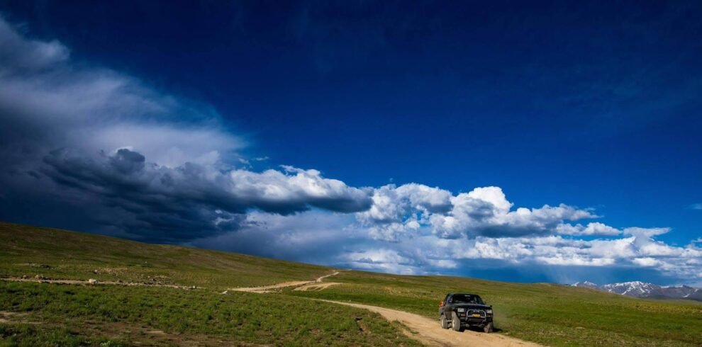 4x4 jeep on a mountain track with the Haldi Cones granite peaks in the background, Ghanche District