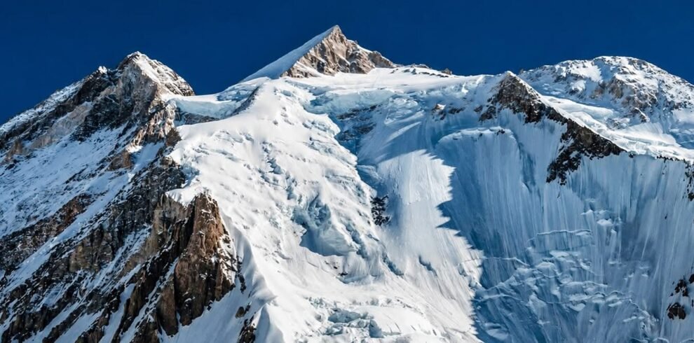 Climbers on the southwest ridge of Gasherbrum II with Karakoram peaks in the background