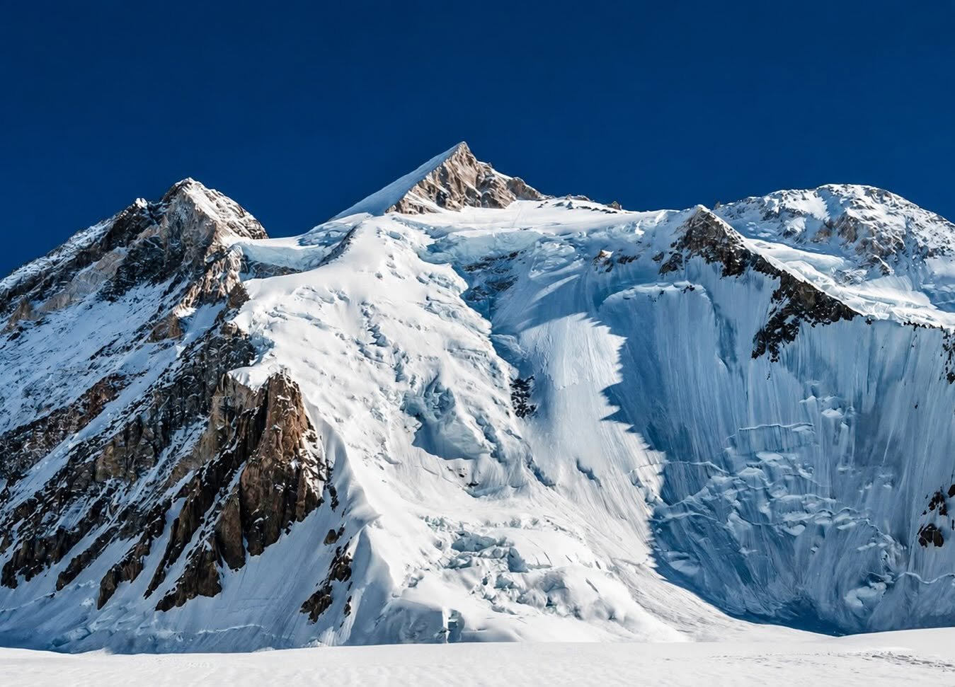 Climbers on the southwest ridge of Gasherbrum II with Karakoram peaks in the background