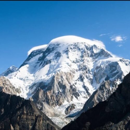 Climbers ascending the West Spur of Broad Peak with K2 visible across the glacier, Karakoram