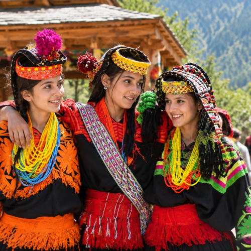 Kalash women in traditional beaded headdresses dancing at the Chilam Joshi spring festival, Bumburet