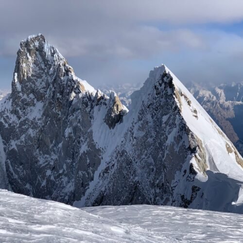 Climbers ascending K6 with the Charakusa Valley and Masherbrum range below, Karakoram
