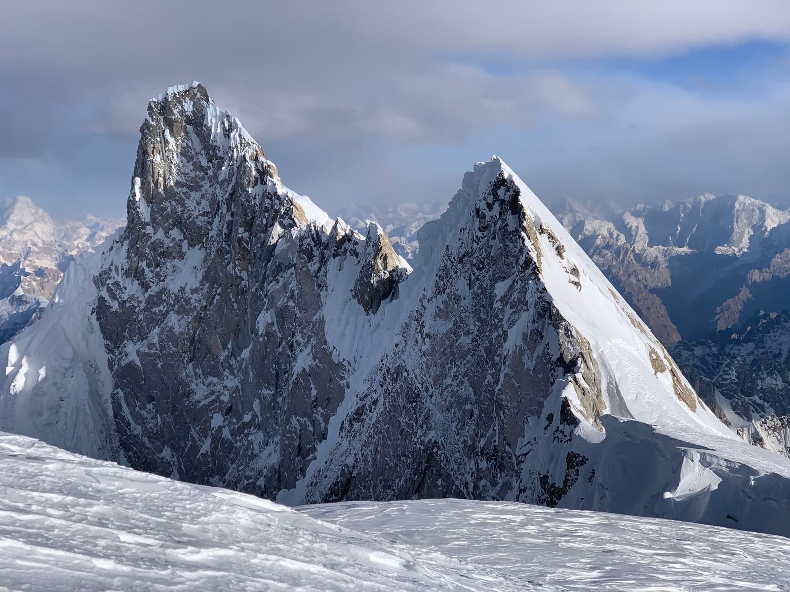 Climbers ascending K6 with the Charakusa Valley and Masherbrum range below, Karakoram
